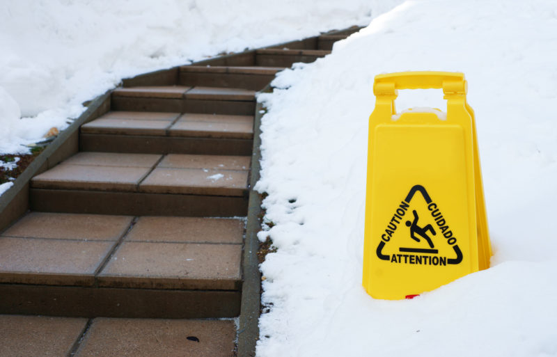 Caution sign next to slippery steps