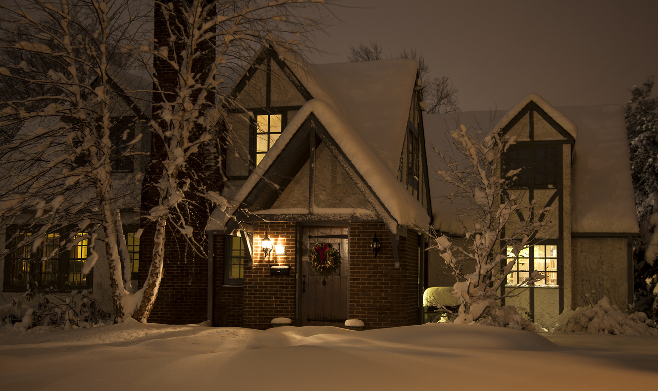 snow covered house at night