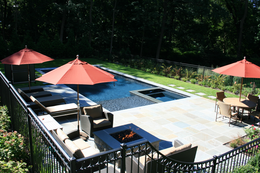 Backyard pool with hot tub and stone patio