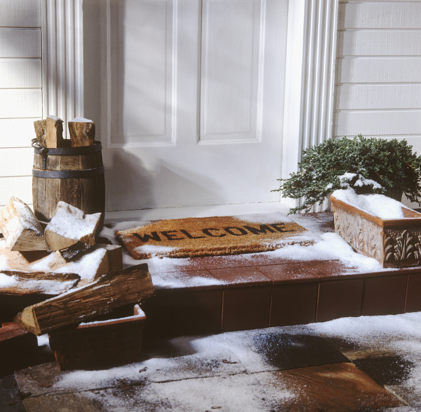 Snowy steps leading to front door of house