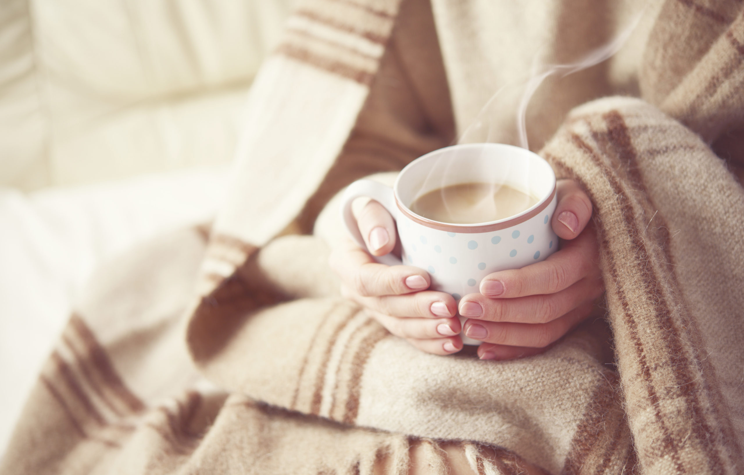 Woman holding hot coffee