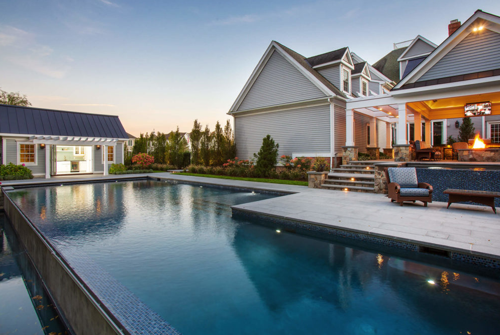 Backyard view of a home's swimming pool and patio