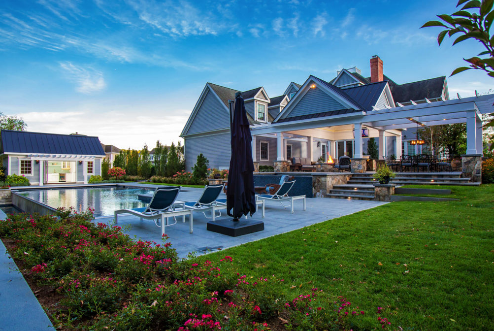 Backyard pool and patio view of a home designed by Ambrosio Landscape Solutions