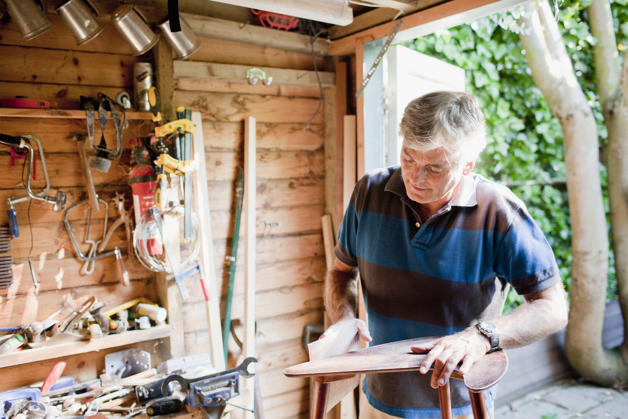 Man sanding wood in workshop