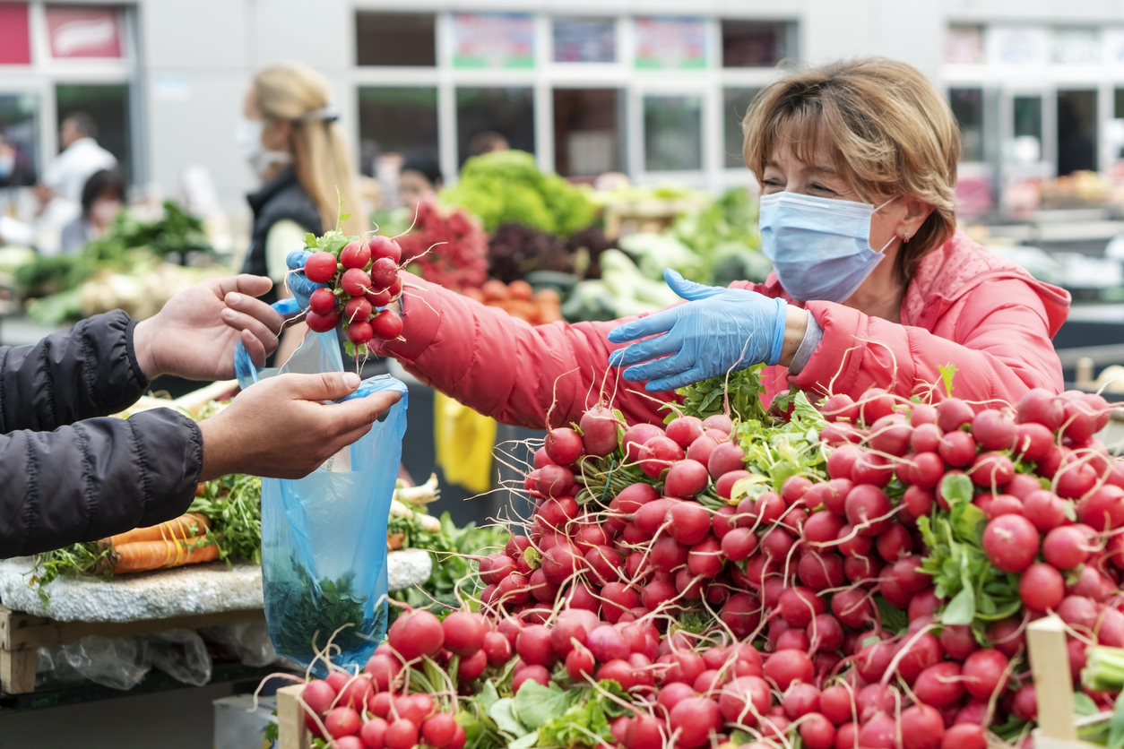 Woman shopping in the farmer's market during COVID-19 crisis.