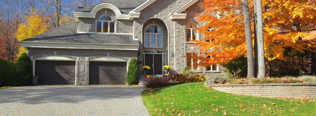 Large Luxurious Autumn House with leaves on the lawn