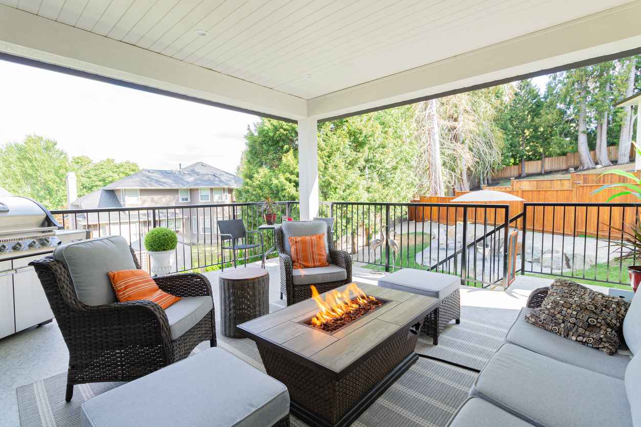 A spacious patio space with a fire pit table heater