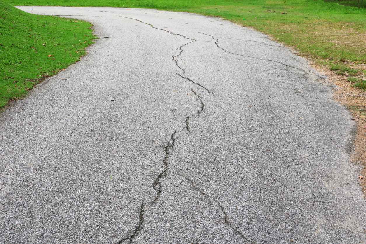 asphalt road cracked in driveway