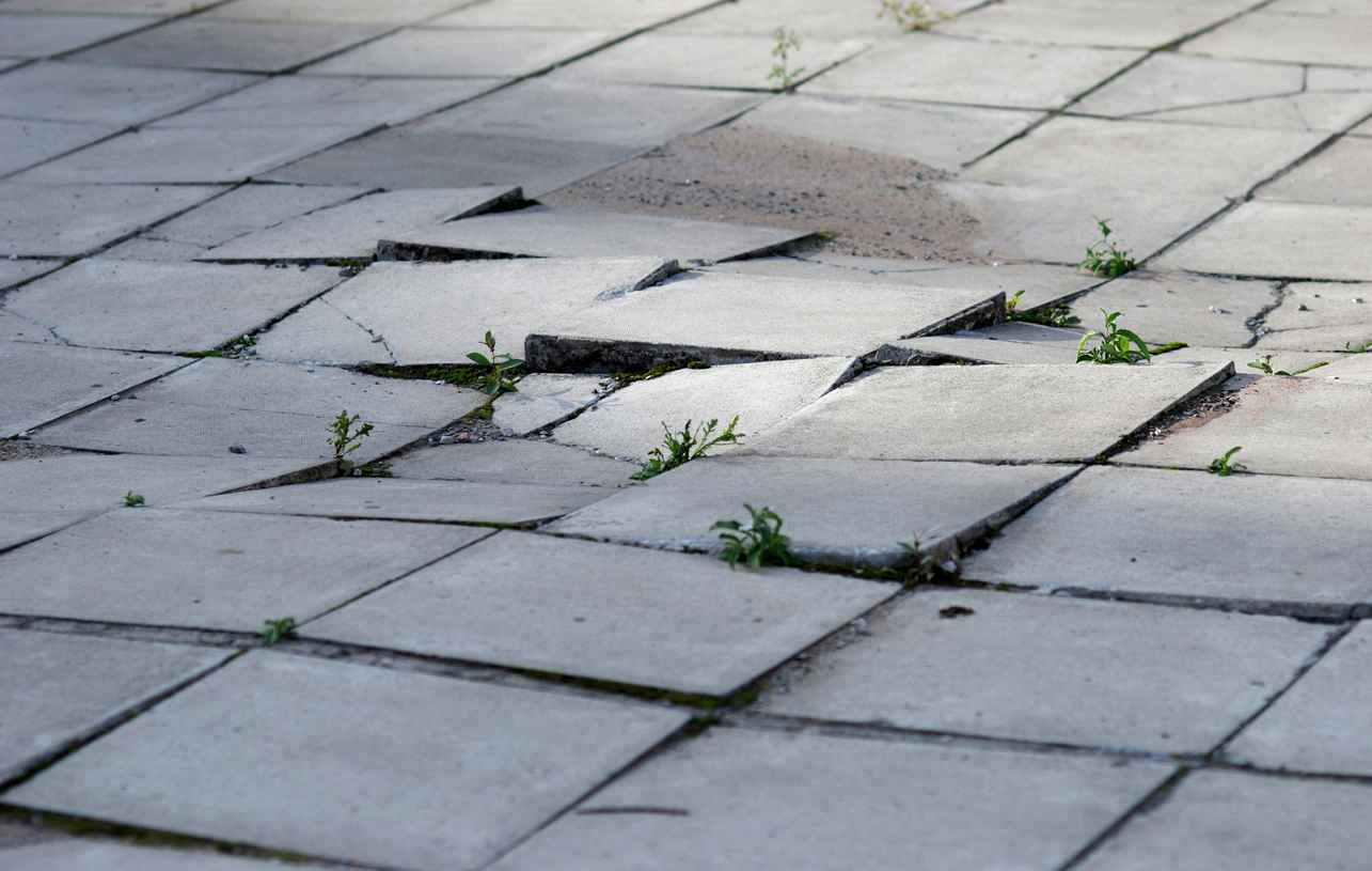 Uneven and cracked walkway tiles/pavement