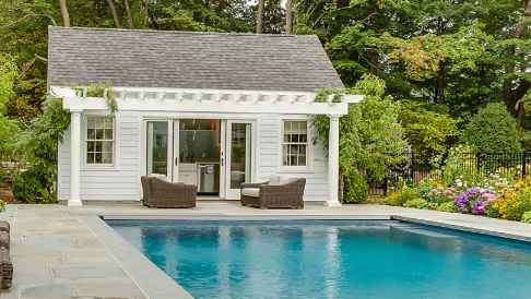 Exterior view of a pool house designed and built by Ambrosio Landscape Solutions