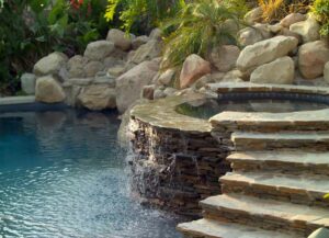 A backyard swimming pool and hot tub; 2024 Pool Design Trends