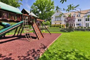 Large backyard with a playground for kids