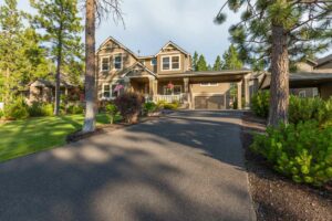 Front elevation and asphalt driveway of a beautiful suburban home.