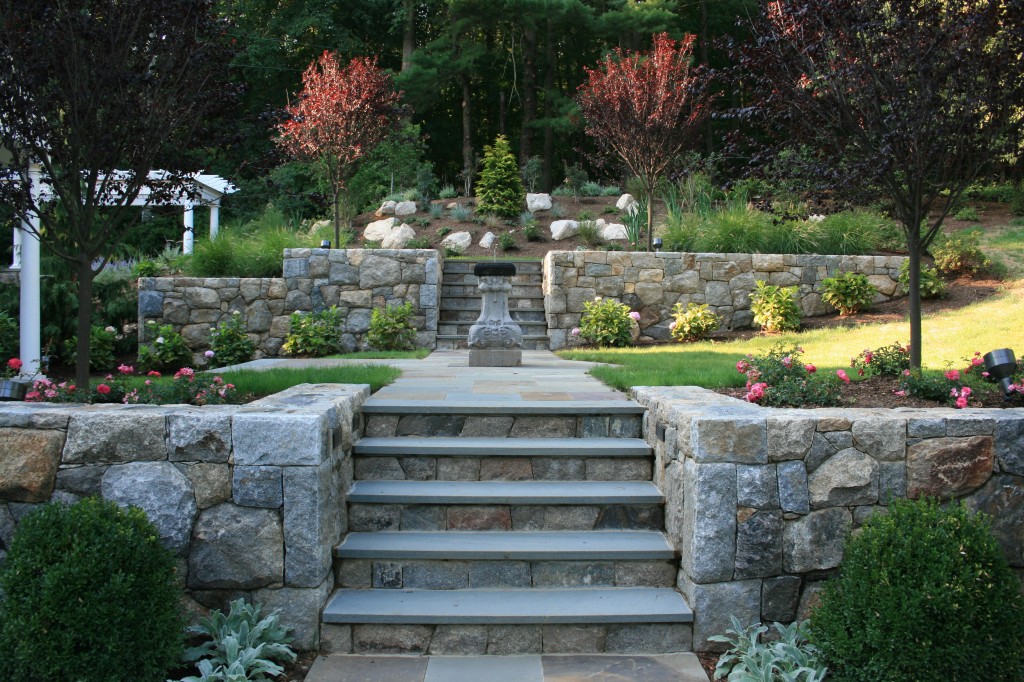 Stone steps leading up to lawn with fountain