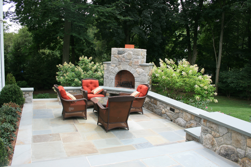 Stone fireplace and chairs outside
