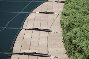 Pool cover hooked onto patio
